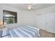 This bedroom features a window, ceiling fan, and closet with white doors at 19269 Serafina St, Venice, FL 34293