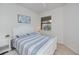 This is a bedroom featuring a bed, a window, and a white nightstand at 19269 Serafina St, Venice, FL 34293