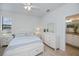 Bright bedroom with a bed, bedside tables, and ensuite bath at 19269 Serafina St, Venice, FL 34293