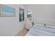 A cozy bedroom featuring a bed and a window with a beautiful lake view at 19269 Serafina St, Venice, FL 34293