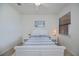 This bedroom features a cozy bed with a striped blue and white blanket and side tables on each side at 19269 Serafina St, Venice, FL 34293