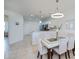 Open-concept dining area with views into the kitchen and living spaces, modern decor at 19269 Serafina St, Venice, FL 34293