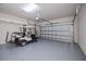 Spacious garage with a golf cart, epoxy flooring, shelving and an insulated garage door at 19269 Serafina St, Venice, FL 34293