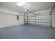 Garage features epoxy flooring, an automatic door opener, and overhead storage racks, offering plenty of space at 19269 Serafina St, Venice, FL 34293