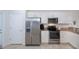 Bright kitchen features stainless steel appliances and white cabinetry at 19269 Serafina St, Venice, FL 34293