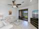 Inviting living room showcasing water views, comfortable seating, and a ceiling fan at 19269 Serafina St, Venice, FL 34293