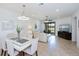 Bright open-concept living space with tile floors, modern lighting, and sliding doors to outdoor living area at 19269 Serafina St, Venice, FL 34293