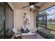 Charming screened lanai with a cozy table and chairs, perfect for outdoor entertaining with lake views at 19269 Serafina St, Venice, FL 34293