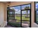 Relaxing screened lanai with views of the lake, palm trees, and beautiful landscaping at 19269 Serafina St, Venice, FL 34293