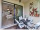 Screened-in patio featuring a comfortable seating area with views of the well-lit, adjacent living spaces at 19269 Serafina St, Venice, FL 34293