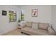 Bright sitting area with large windows, neutral-toned sofa, and stylish decor provides a cozy space at 19269 Serafina St, Venice, FL 34293