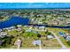 Wide aerial view of the residential neighborhood with water access and lush landscaping at 20430 Edgewater Dr, Port Charlotte, FL 33952