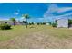 Large backyard with palm trees and storage shed at 20430 Edgewater Dr, Port Charlotte, FL 33952