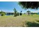 Expansive backyard featuring tropical landscaping, mature trees, and ample green space at 20430 Edgewater Dr, Port Charlotte, FL 33952