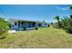 The backyard features a screened lanai and ample space for outdoor enjoyment and gardening at 20430 Edgewater Dr, Port Charlotte, FL 33952