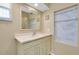 Bathroom featuring single vanity, framed mirror and glass-enclosed shower with unique tile at 20430 Edgewater Dr, Port Charlotte, FL 33952