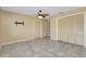 Bedroom with ceiling fan and tile floors, along with a closet for storage at 20430 Edgewater Dr, Port Charlotte, FL 33952