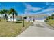 Well-maintained single-story home featuring an attached two-car garage and a spacious driveway at 20430 Edgewater Dr, Port Charlotte, FL 33952