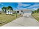 Well-maintained single-story home featuring an attached two-car garage and a spacious driveway at 20430 Edgewater Dr, Port Charlotte, FL 33952
