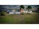 Charming single-story home with two palm trees, a well maintained lawn, and a white exterior at 20430 Edgewater Dr, Port Charlotte, FL 33952