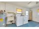 Bright laundry room with washer, dryer, utility sink, and shelving at 20430 Edgewater Dr, Port Charlotte, FL 33952