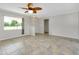 Spacious living room with large windows and stylish ceiling fan at 20430 Edgewater Dr, Port Charlotte, FL 33952