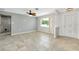 Bright living room featuring tile flooring, ceiling fan, and neutral decor at 20430 Edgewater Dr, Port Charlotte, FL 33952