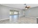 Bright living room featuring tile flooring, ceiling fan, and open layout at 20430 Edgewater Dr, Port Charlotte, FL 33952