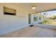The screened porch area is equipped with wood-look tile and ceiling fan at 20430 Edgewater Dr, Port Charlotte, FL 33952