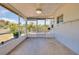 The covered and screened porch includes tile floors and access to the yard at 20430 Edgewater Dr, Port Charlotte, FL 33952