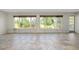 Bright sunroom with large windows offering scenic backyard views at 20430 Edgewater Dr, Port Charlotte, FL 33952