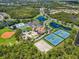 Aerial view of the community amenities including tennis courts, volley ball and a pool at 2146 Snapdragon Ln, Venice, FL 34292