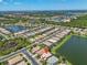 Expansive aerial shot showcasing a residential area with multiple ponds, mature trees, and well-maintained streets at 2146 Snapdragon Ln, Venice, FL 34292