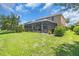 A spacious backyard with screened in lanai and lush landscaping at 2146 Snapdragon Ln, Venice, FL 34292
