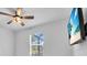 Bright bedroom has a ceiling fan, and a wall mounted TV and a pleasant view at 2146 Snapdragon Ln, Venice, FL 34292