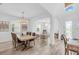 Bright dining room boasts an open floor plan with wood flooring and elegant lighting fixtures at 2146 Snapdragon Ln, Venice, FL 34292
