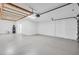 Spacious garage with lift, white walls, finished floors, and utility sink at 2146 Snapdragon Ln, Venice, FL 34292