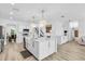 Modern kitchen features a spacious island, stainless steel appliances, and sleek white cabinetry at 2146 Snapdragon Ln, Venice, FL 34292