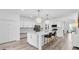 Bright kitchen boasts a spacious island with seating, stainless steel appliances, and stylish pendant lighting at 2146 Snapdragon Ln, Venice, FL 34292