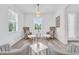 Bright living room with wood flooring, comfortable seating arrangements, and a scenic view at 2146 Snapdragon Ln, Venice, FL 34292