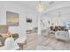 Open-concept living space with modern furniture, wood flooring, and plenty of natural light at 2146 Snapdragon Ln, Venice, FL 34292