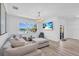 Cozy living room overlooking the water features a comfortable sofa and scenic views at 2146 Snapdragon Ln, Venice, FL 34292