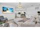 Open-concept living room featuring modern decor, hardwood floors, and a seamless transition to the kitchen at 2146 Snapdragon Ln, Venice, FL 34292