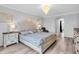 Main bedroom featuring a decorative headboard, modern decor, and soft, natural lighting at 2146 Snapdragon Ln, Venice, FL 34292