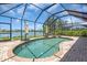 Screened-in pool and spa overlooking a serene lake view with open sky above at 2146 Snapdragon Ln, Venice, FL 34292