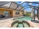 A screened-in pool and hot tub on a brick patio. The enclosure is attached to the home at 2146 Snapdragon Ln, Venice, FL 34292