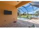 Screened lanai featuring a pool, spa, patio with a lake view, and an outdoor TV at 2146 Snapdragon Ln, Venice, FL 34292