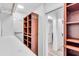 Walk-in closet with custom shelving and storage solutions for optimal organization at 2146 Snapdragon Ln, Venice, FL 34292