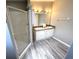 Bathroom featuring a double sink vanity, a large mirror, and a glass enclosed shower at 217 Blackburn Blvd, North Port, FL 34287