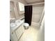 Bathroom featuring a vanity with a sink, a toilet, shelving, and a shower tub combo at 217 Blackburn Blvd, North Port, FL 34287